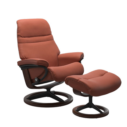 Henna colored sunrise recliner with matching ottoman featuring a curved base in metal and brown