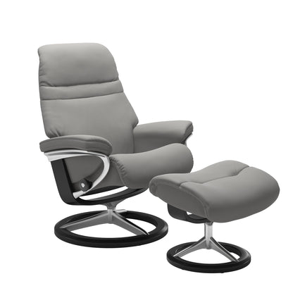 SIlver grey colored sunrise recliner with matching ottoman featuring a curved  black wood and metal base