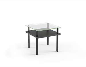 Modern glass top side table with charcoal stained ash wood shelf and black metal legs 