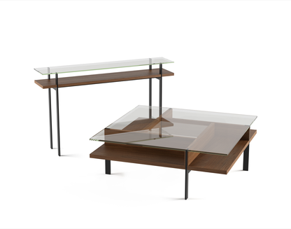 Modern glass top coffee table with walnut wood shelf and black metal  legs in front of a sideboard table matching same description