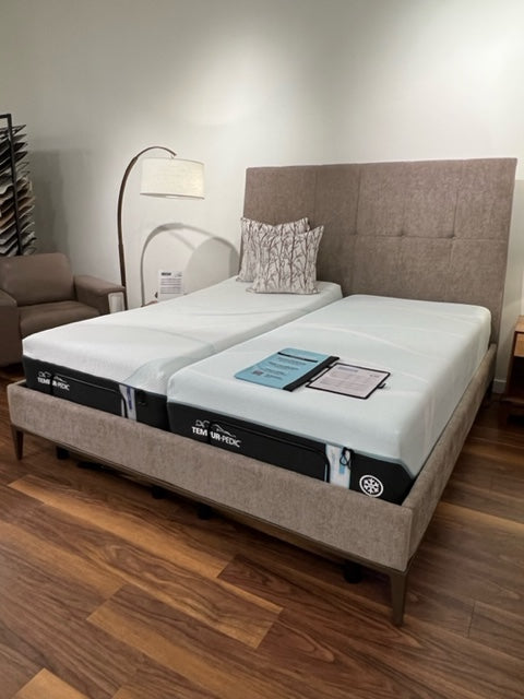 Brown Upholstered bed with tufted headboard in showcase setting 