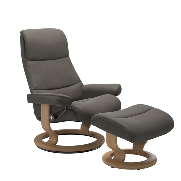 Recliner with matching ottoman in metal grey with classic round wooden base in oak with padded arrest. 